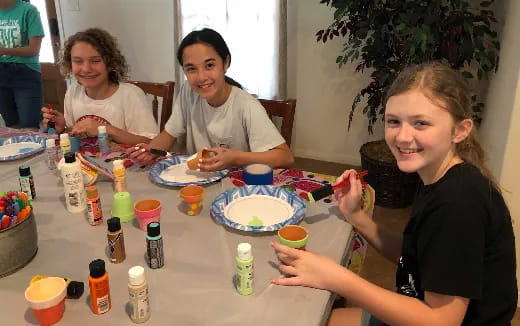 a group of people sitting around a table with food