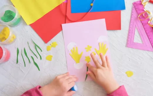 a child's hands holding a piece of paper