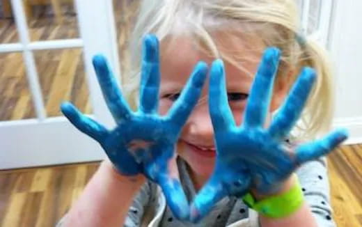 a girl with a blue and green toy horse