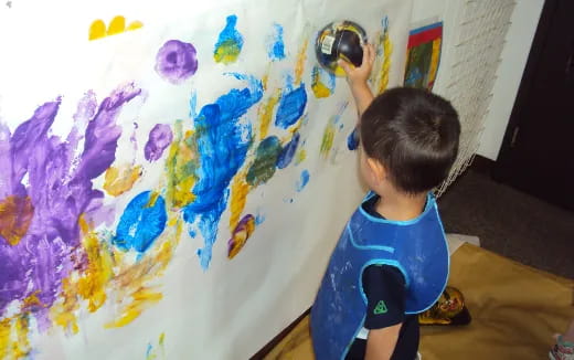 a child painting on a wall