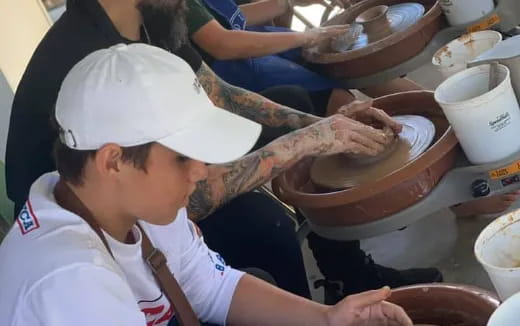 a person pouring a liquid into a bucket