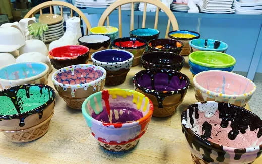 a table full of colorful bowls