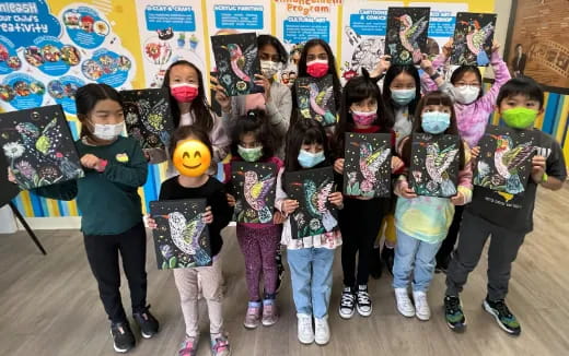 a group of children holding books