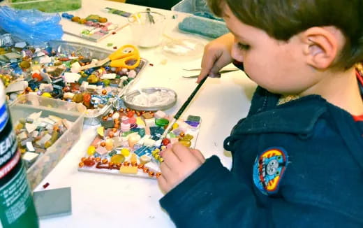 a boy painting on a table