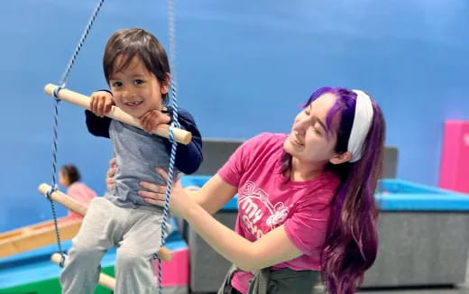 a person and a child on a swing