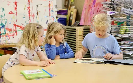 a few children sitting at a table