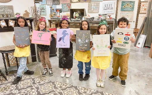 a group of children holding signs