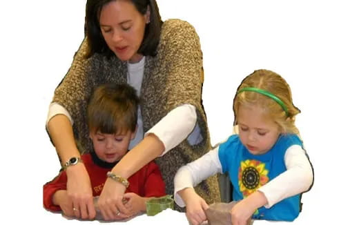 a person and children looking at a book