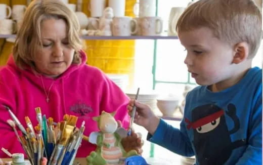 a young boy and girl painting