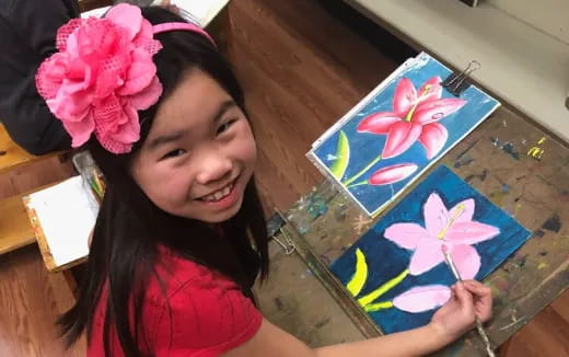 a girl holding a painting