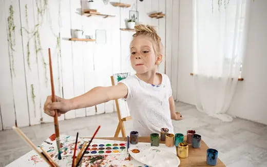 a girl painting on a table