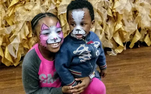 a group of children with face paint