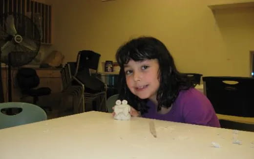 a girl sitting at a table