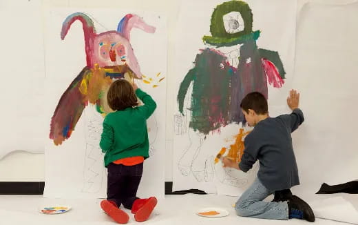 children painting on a wall