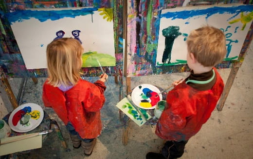 children painting on a wall