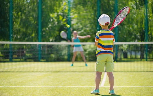 a boy holding a tennis racket