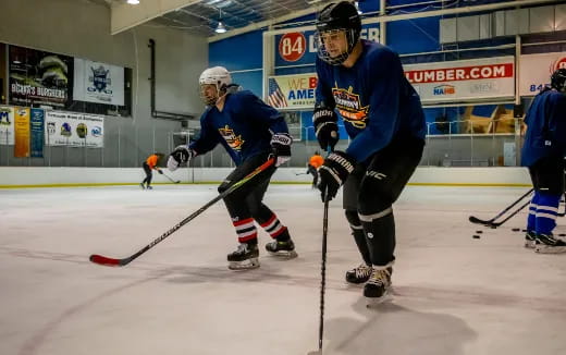 a couple of men playing hockey