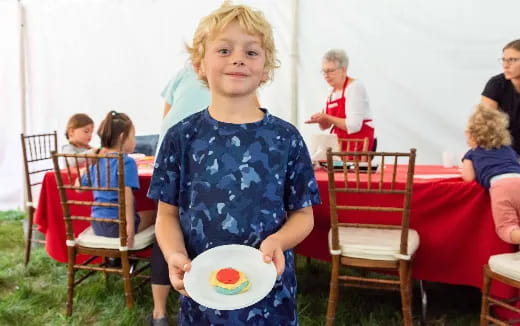 a boy holding a plate