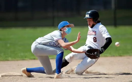 a couple of women playing baseball