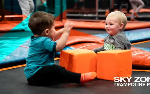 a couple of young boys playing on a playground