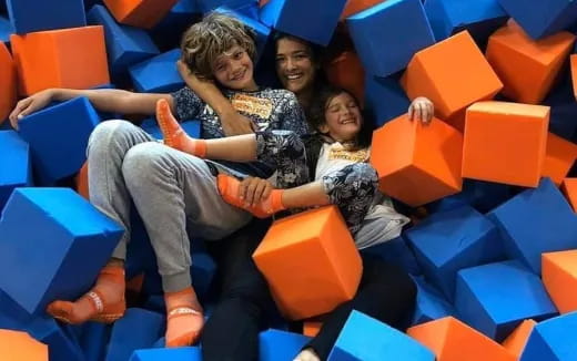 a group of people sitting on a colorful slide