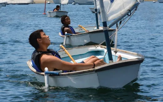 a man and a woman on a boat in the water