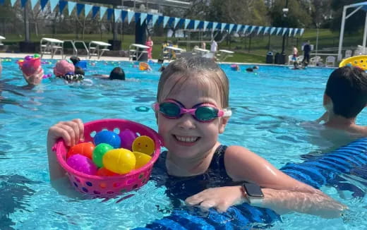 a girl in a pool with balls