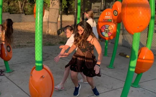 a person and a boy playing on a playground