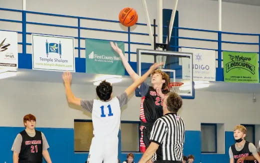 a group of people playing basketball