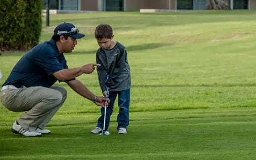 a man and a boy playing golf