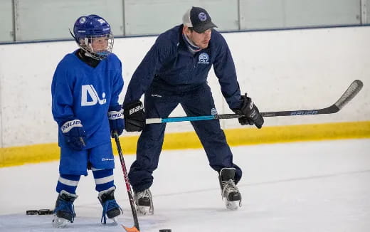 a man and a boy playing hockey