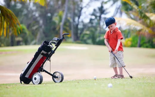 a boy playing golf