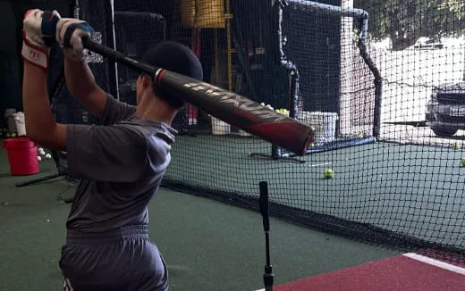 a boy swinging a baseball bat