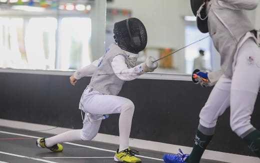 a person wearing a helmet and holding a hockey stick