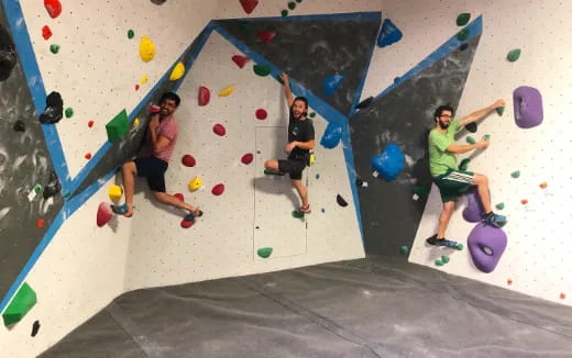 a group of people climbing a rock wall