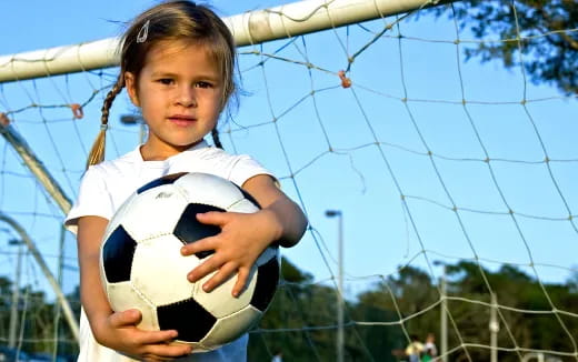 a girl holding a ball