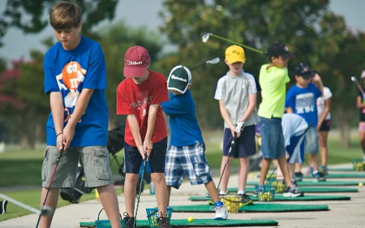 a group of kids playing mini golf