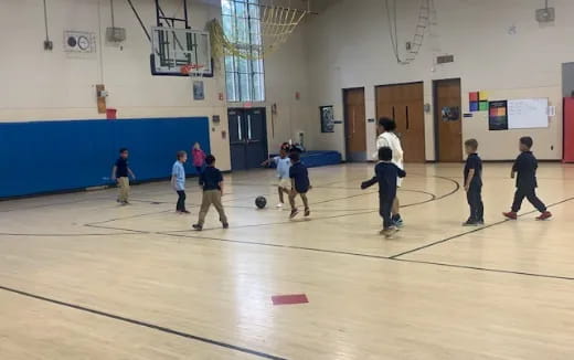 a group of kids playing basketball