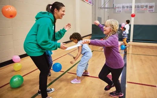 a person and two children playing with balls