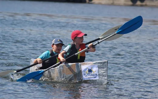 a couple of people rowing a boat