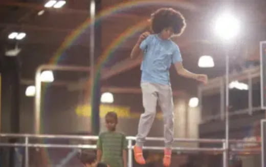 a man jumping on a trampoline