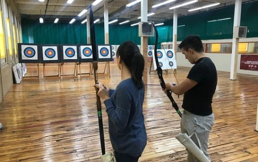 a man and a woman holding a bow and arrow