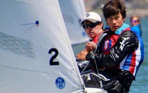 a group of people in a sailboat