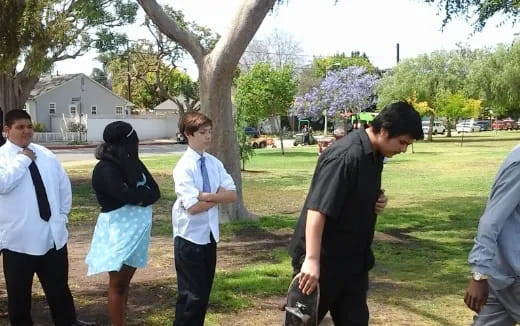 a group of people standing in a park