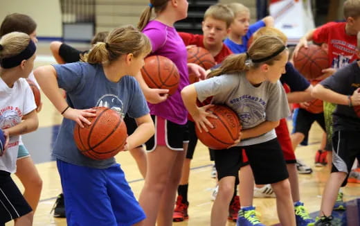 a group of girls playing basketball