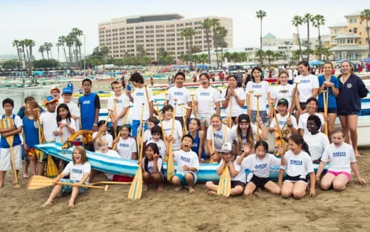 a group of people posing for a photo on a beach