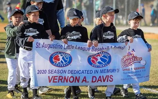 a group of kids holding a banner