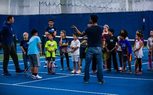 a group of people holding tennis rackets