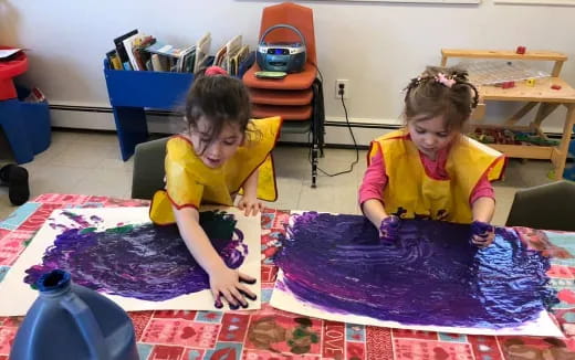 a couple of children playing on a rug in a room