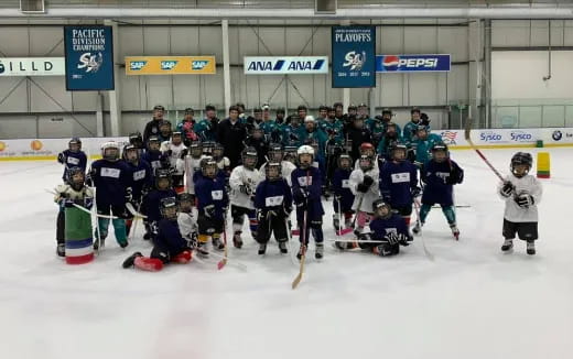 a group of people wearing hockey uniforms and holding hockey sticks